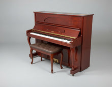 Load image into Gallery viewer, Wooden upright piano with a bench on a gray floor