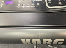Load image into Gallery viewer, Close-up of a Korg electronic device with control panel and branding.