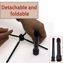 Load image into Gallery viewer, Foldable and detachable 4 leg flute stand with hands demonstrating its features on a white background.
