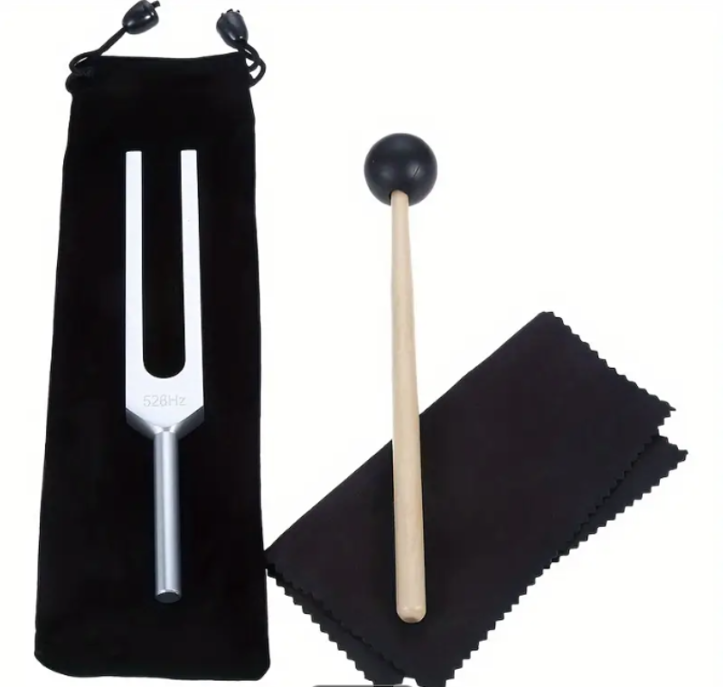 Tuning fork, mallet, and cloth on a white background