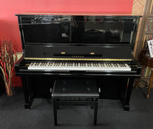 Load image into Gallery viewer, Black Yamaha piano with a bench in a room with red walls and decorative elements.
